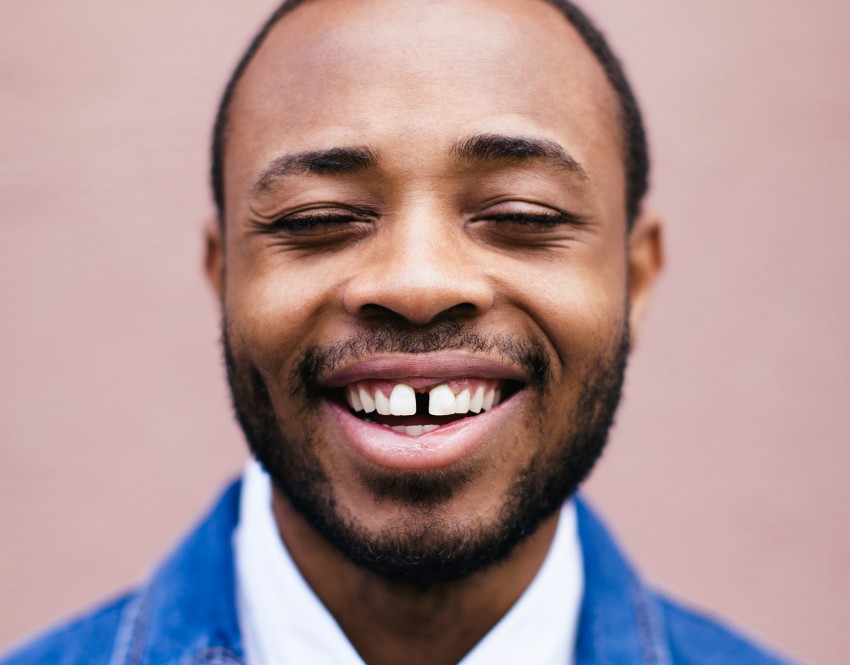Man smiling in blue coat