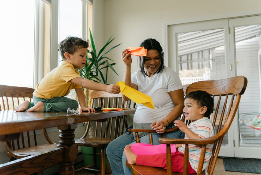 Family making paper airplanes